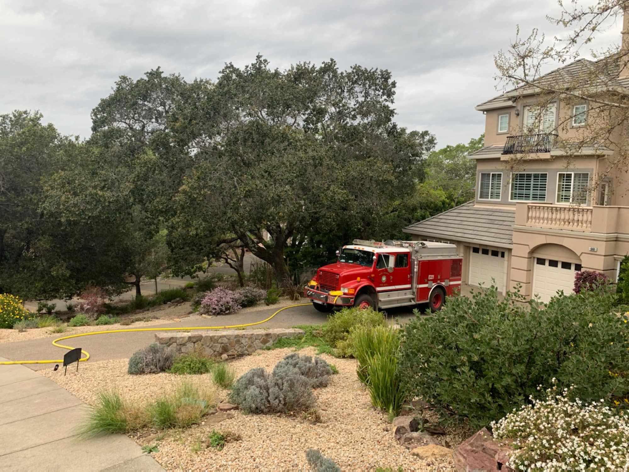 Fire truck rig parked in driveway of home
