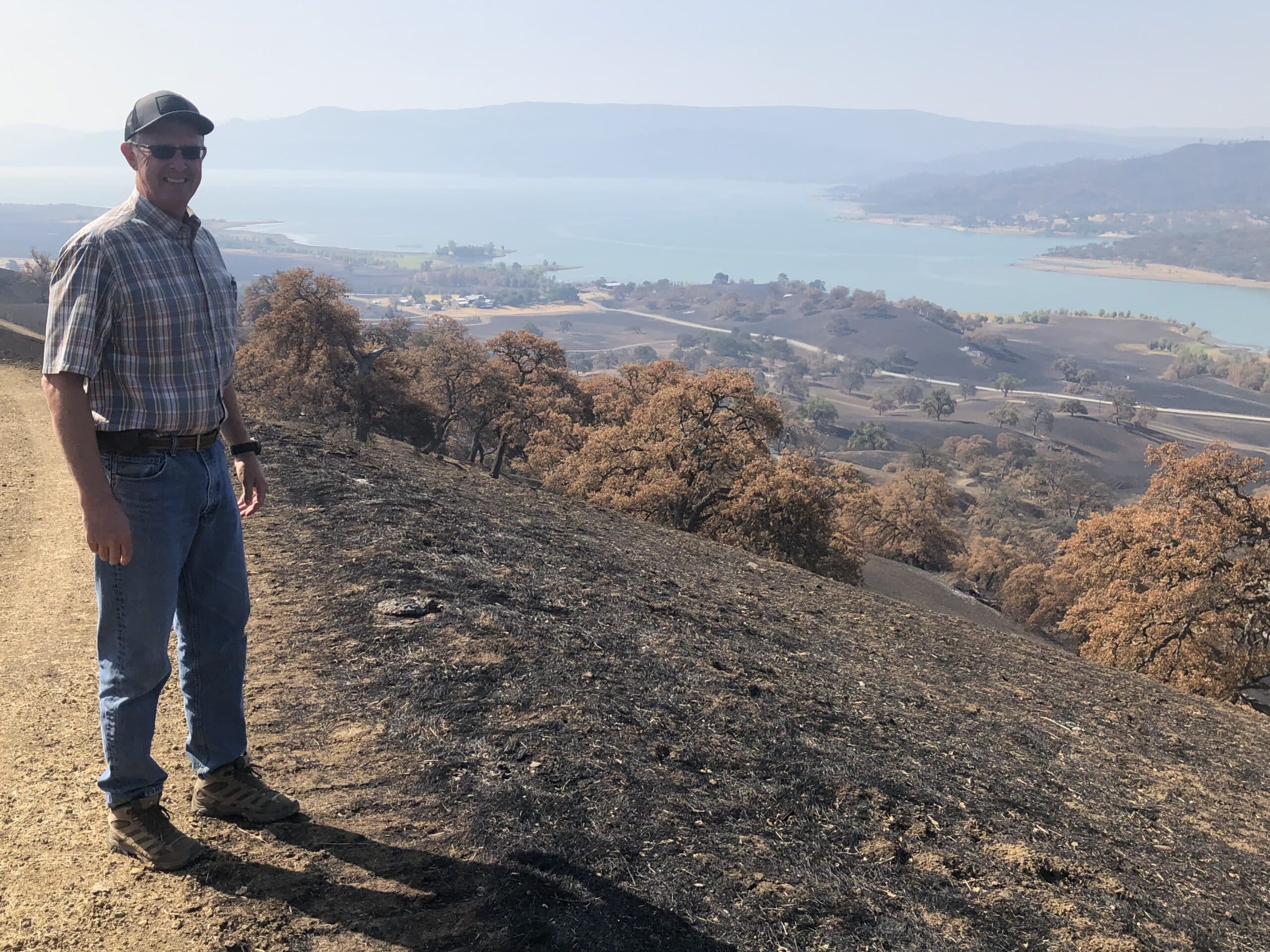 Jim Gamble standing next to Napa burn scar
