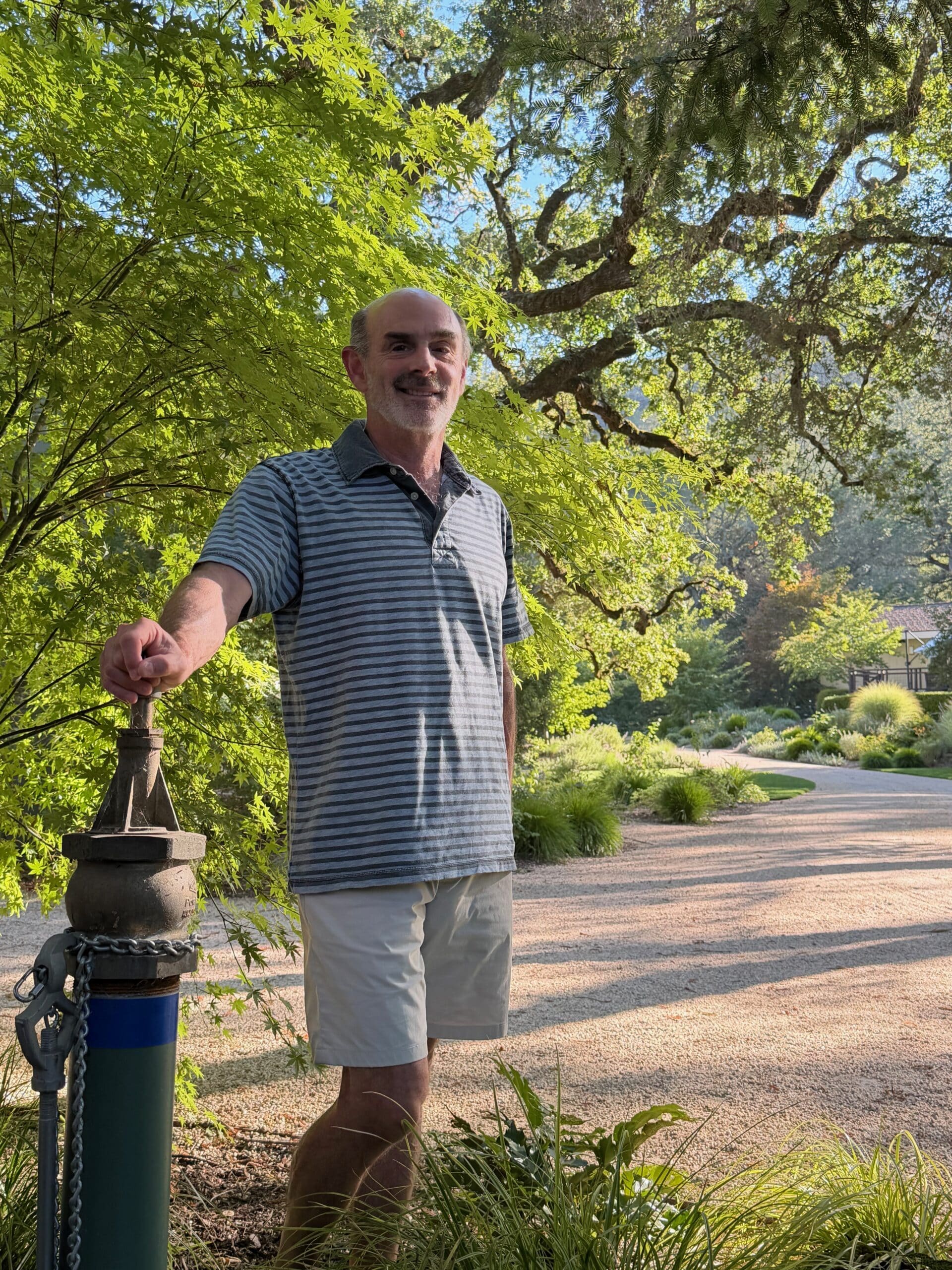 Ted Schlein leaning on one of many water resources on property for wildfire response